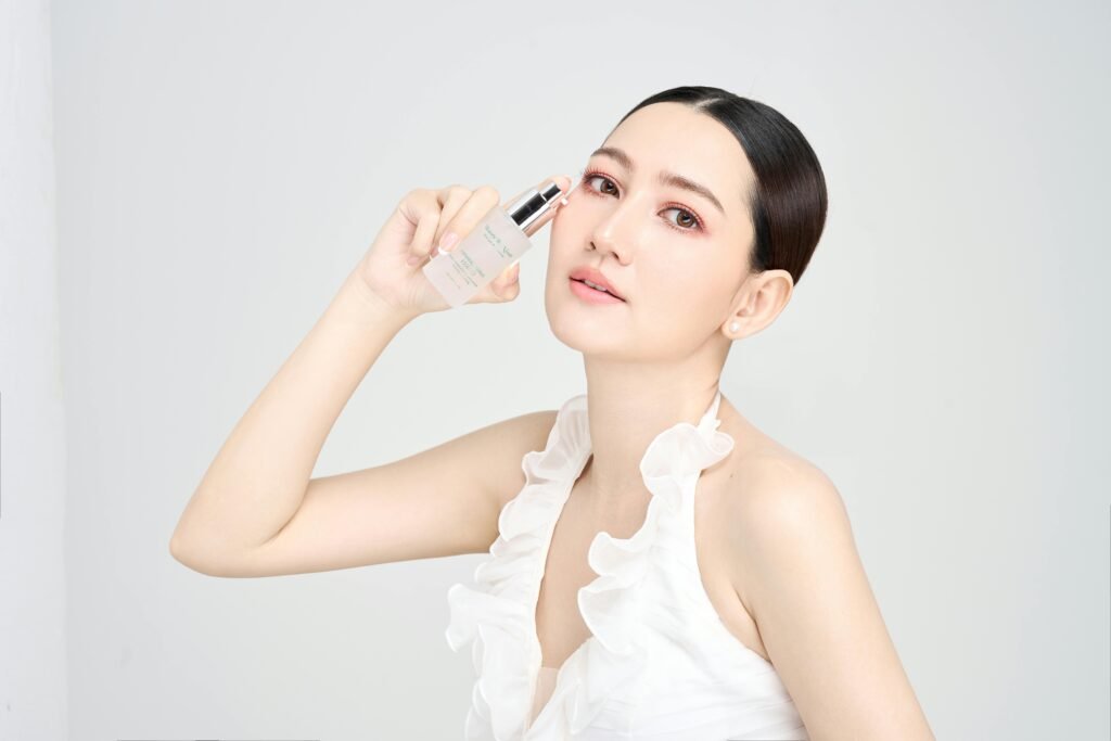 Serene model holding skincare product in modern beauty photoshoot.